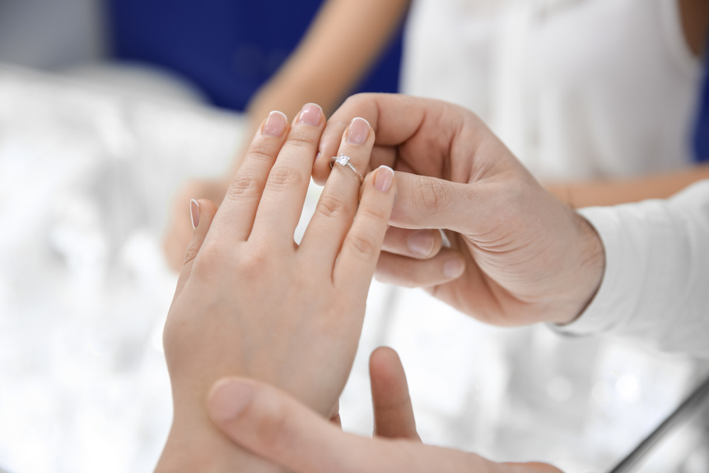 Young,Couple,Choosing,Ring,In,Jewelry,Store