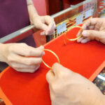 Close,Up,Of,Customer,Is,Checking,Bracelet,Before,Sell,Or