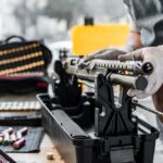 The,Gunsmith,Maintaining,His,Rifle,In,A,Workshop